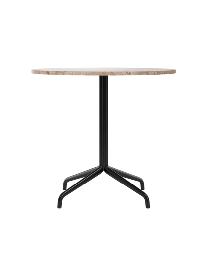 A front view of the Harbour Column Dining Table with a round Kunis Breccia stone top and black metal star-shaped base.