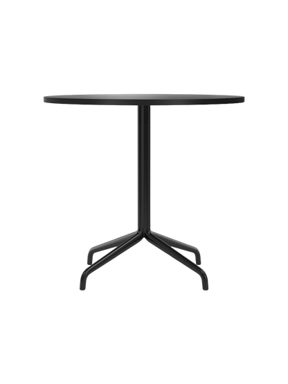 A front view of the Harbour Column Dining Table, featuring a round charcoal linoleum top and a slender black metal star base.