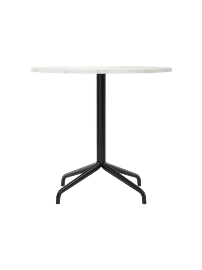 Front view of the Harbour Column Dining Table with a round, white Estremoz marble top and a black star-shaped metal base.