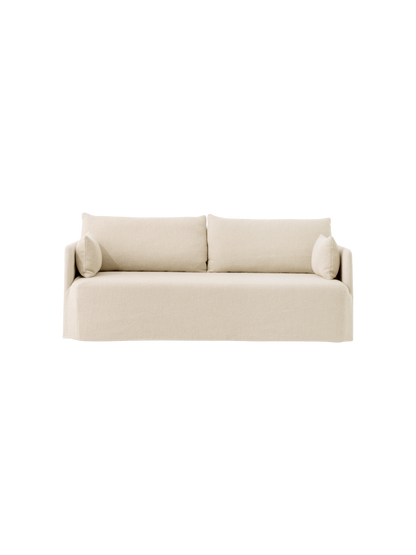 A frontal view of the Offset 2-seater Sofa with a loose cover in a light, textured Logan Jasmine fabric.
