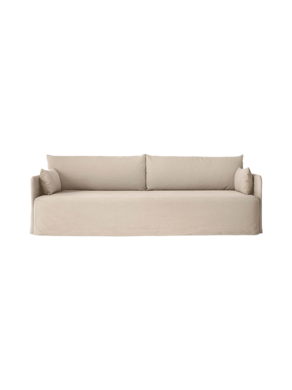 Front view of the Offset 3-Seater Sofa with Loose Cover in sand, with two large back and two smaller side cushions.