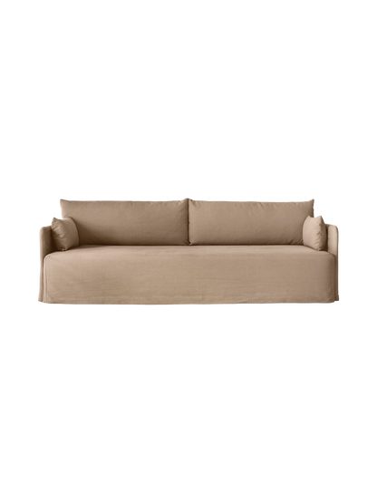 Front view of the 3-seater Offset Sofa. It has a silhouette with a loose cover in textured Flint fabric and soft cushions.