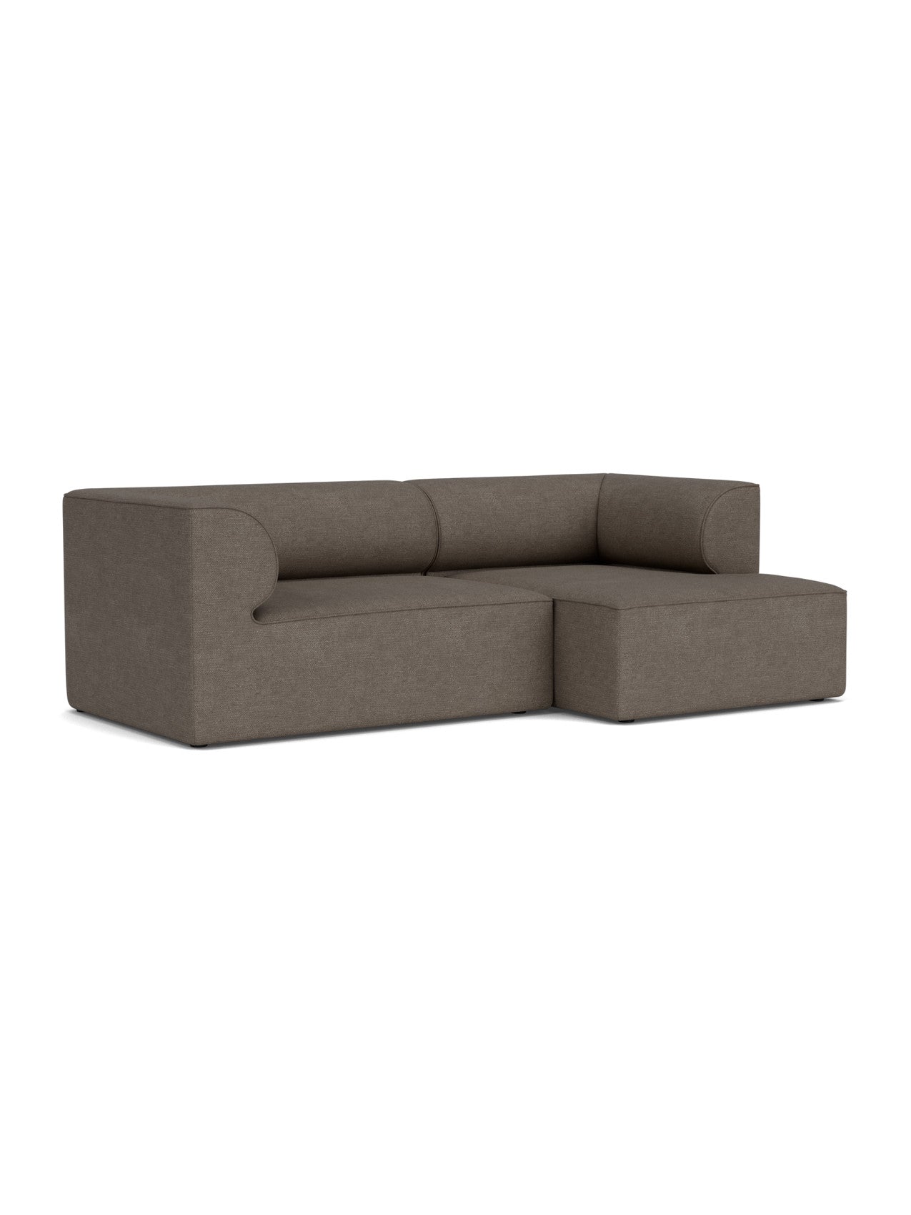 The Eave Modular Sofa, 96, in Configuration 5, shown at an angle. It features a right chaise longue and brown bouclé fabric.