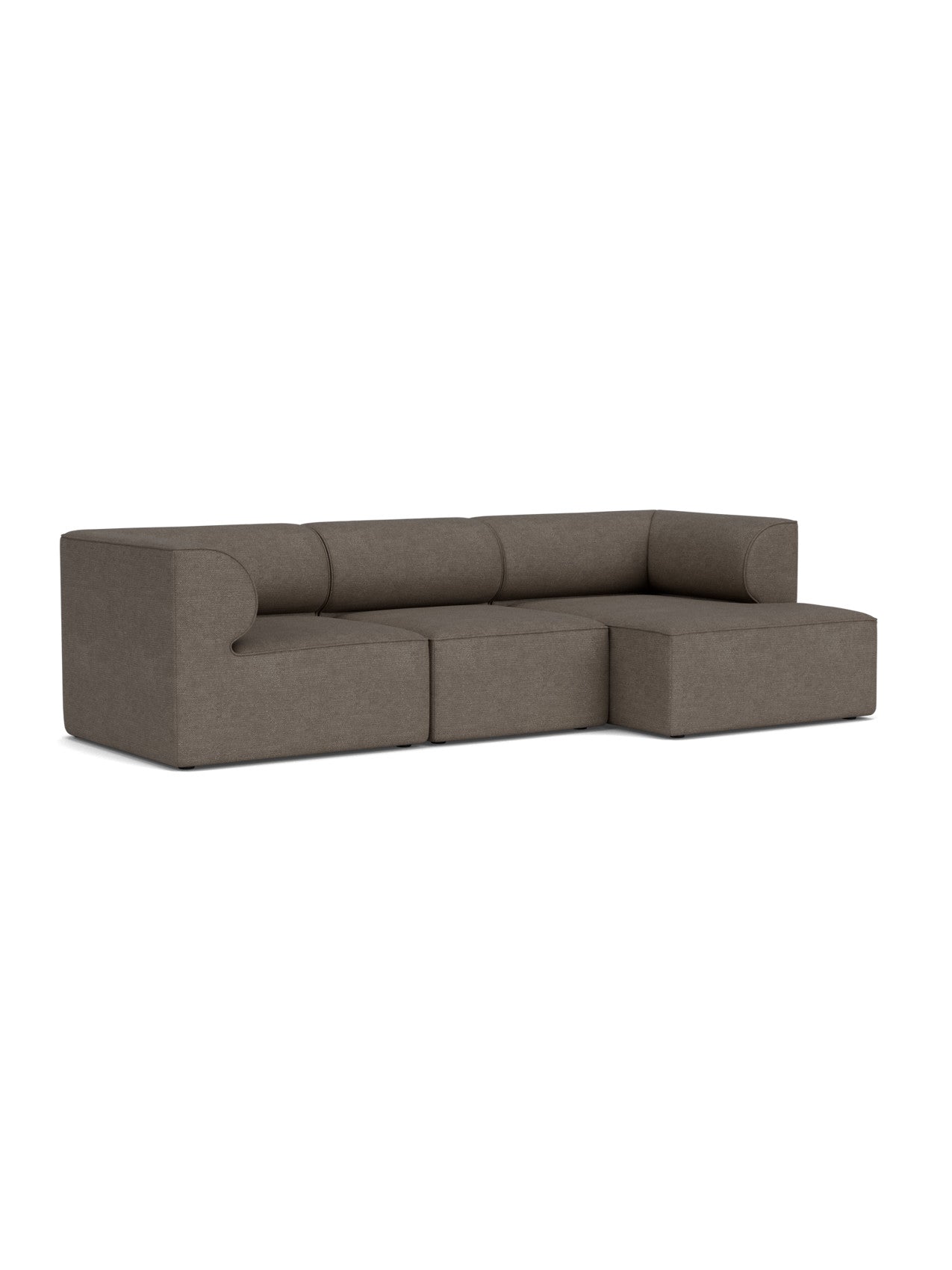 An angled view of the Eave Modular Sofa, Configuration 11. The brown bouclé 3-seater has an L-shape with a chaise longue.
