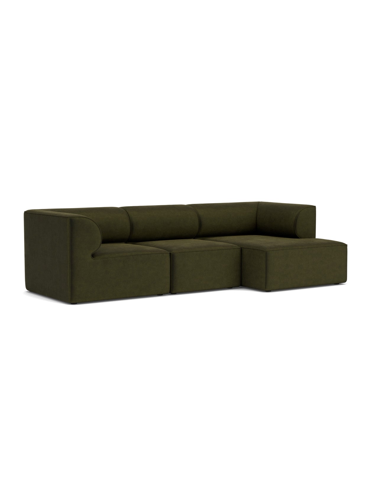 Angled view of the Eave Modular Sofa, 96, 3-seater. The L-shaped sofa in dark green features a right-side chaise longue.