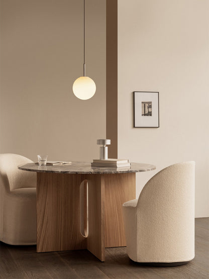 Two cream Tearoom Club Chairs at the Androgyne Dining Table. A TR Bulb Pendant hangs above the grey marble tabletop.