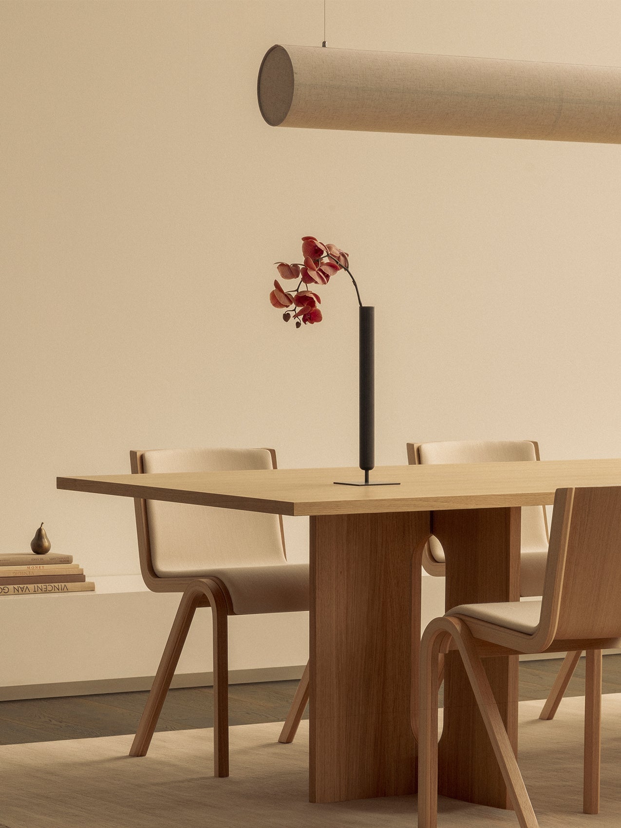 Androgyne Dining Table and Ready Dining Chairs. A Stance Vase sits on the table under a Hashira Linear Pendant light.