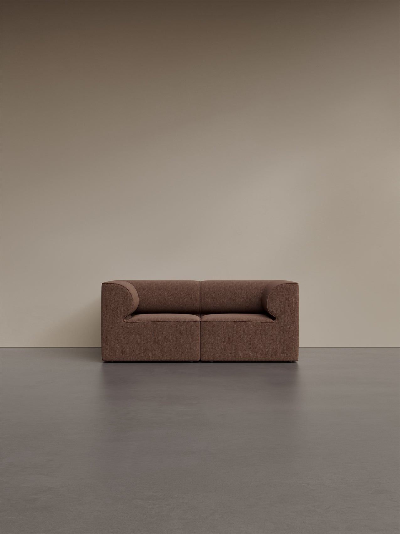 A front view of the Eave Modular Sofa, 86, 2 Seater in a brown bouclé fabric, set against a plain beige wall and dark floor.