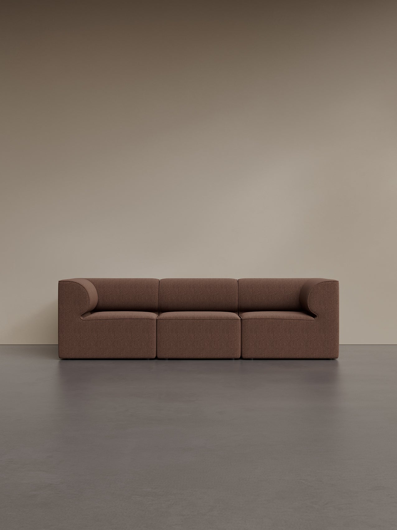 Eave Modular Sofa, 86, 3 Seater, Configuration 2, upholstered in brown fabric, set against a beige wall and dark grey floor.
