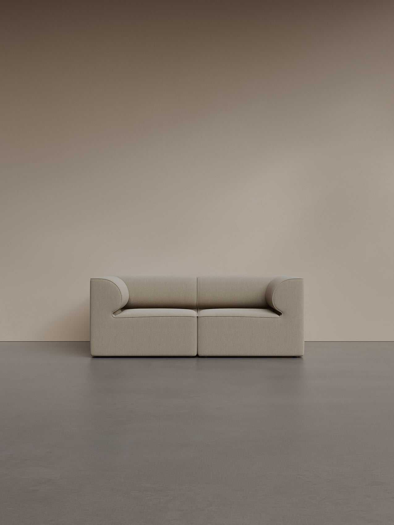 A front view of the Eave Modular Sofa 2-seater in a light bouclé fabric, set against a plain taupe wall in a minimalist room.