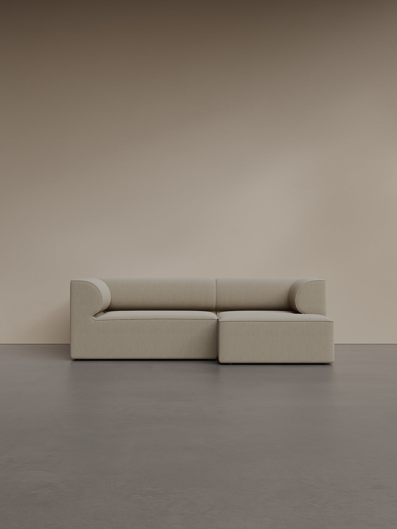 Eave Modular Sofa, 96, 2-seater with a right chaise longue, in light beige bouclé fabric, shown against a plain beige wall.