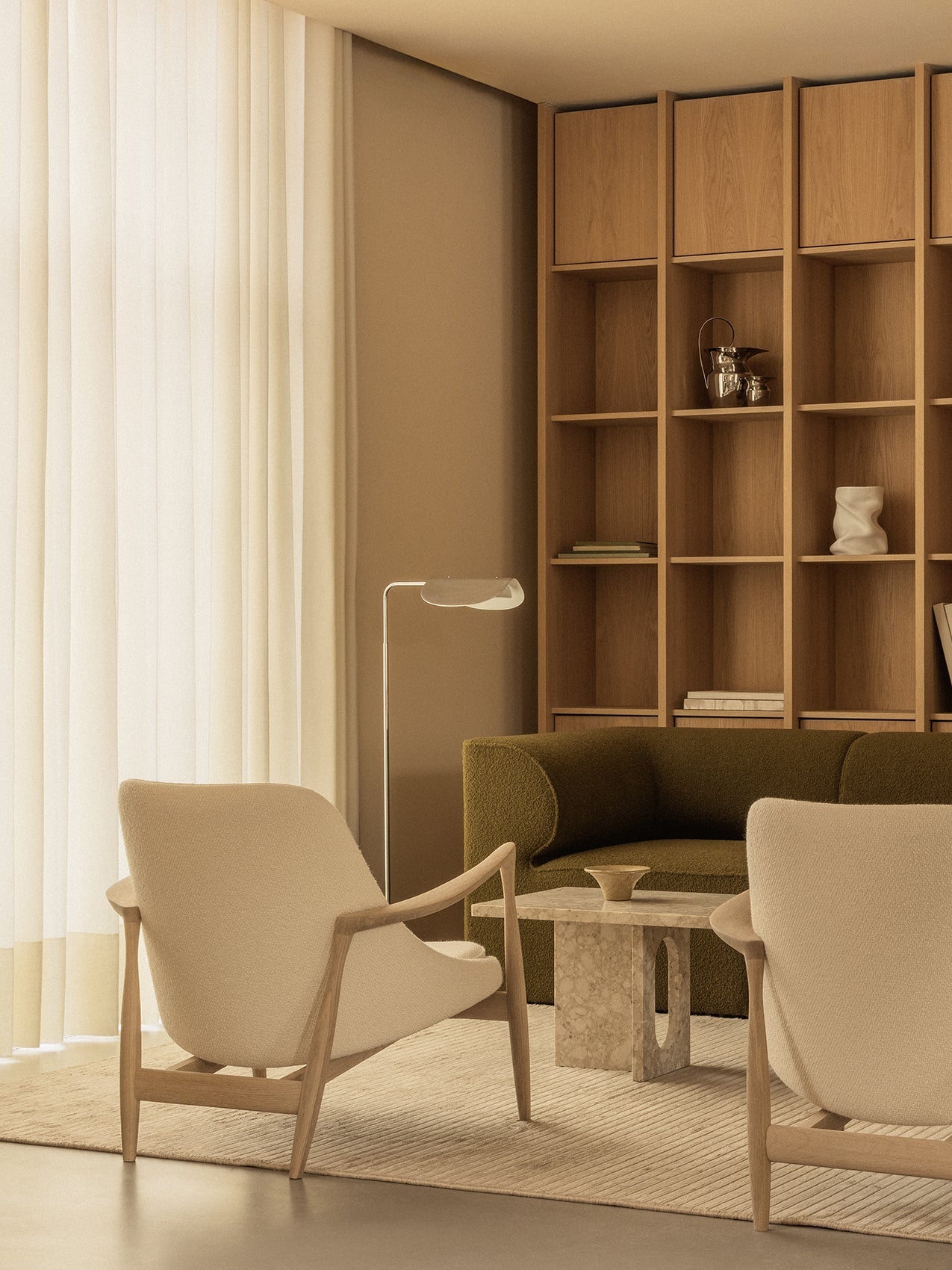 A calm living room with two Elizabeth Lounge Chairs, an Androgyne Lounge Table, an Eave Modular Sofa and a Wing Floor Lamp.