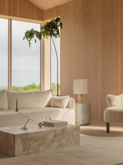 A tranquil, wood-panelled lounge with a Nonna Table Lamp, cream Offset Sofa, marble Plinth Low table and an Ingeborg chair.