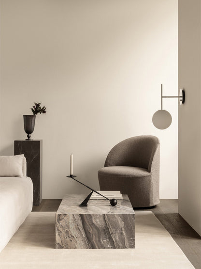 Lifestyle image of a Tearoom Lounge Chair, Plinth Low table in Grey Galaxy marble, and a TR Bulb Suspended Wall Lamp.