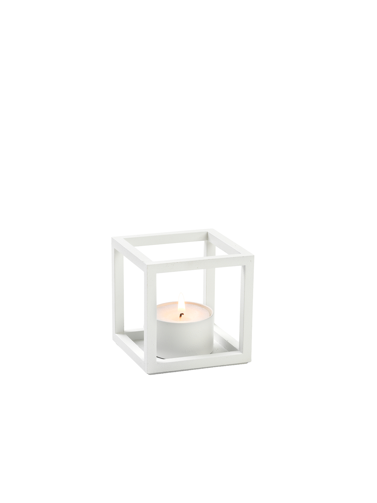 The white Kubus T tealight holder, a minimalist cube-shaped frame, shown at an angle with a lit white candle inside.
