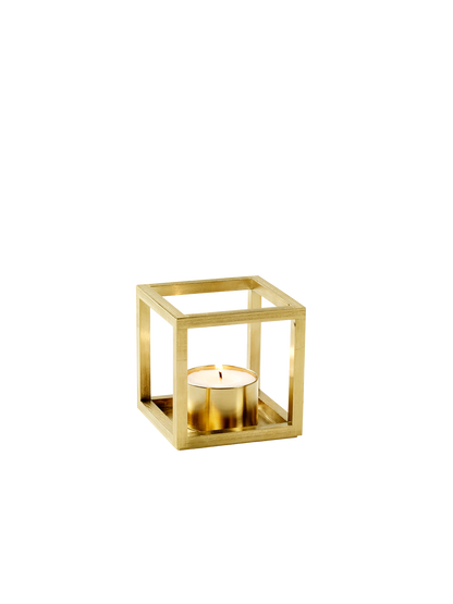 A gold-plated Kubus T tealight holder with a square frame design and a lit tealight candle inside on a white background.
