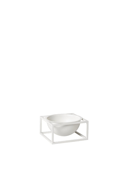 The small Kubus Bowl Centerpiece in white, featuring a round bowl held within a minimalist, square metal frame.