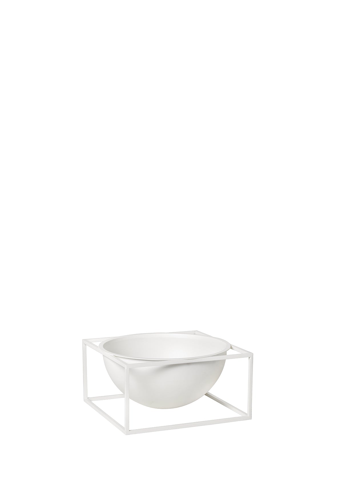 The large, white Kubus Bowl Centerpiece, a deep hemispherical bowl, rests within a square metal frame of the same colour.