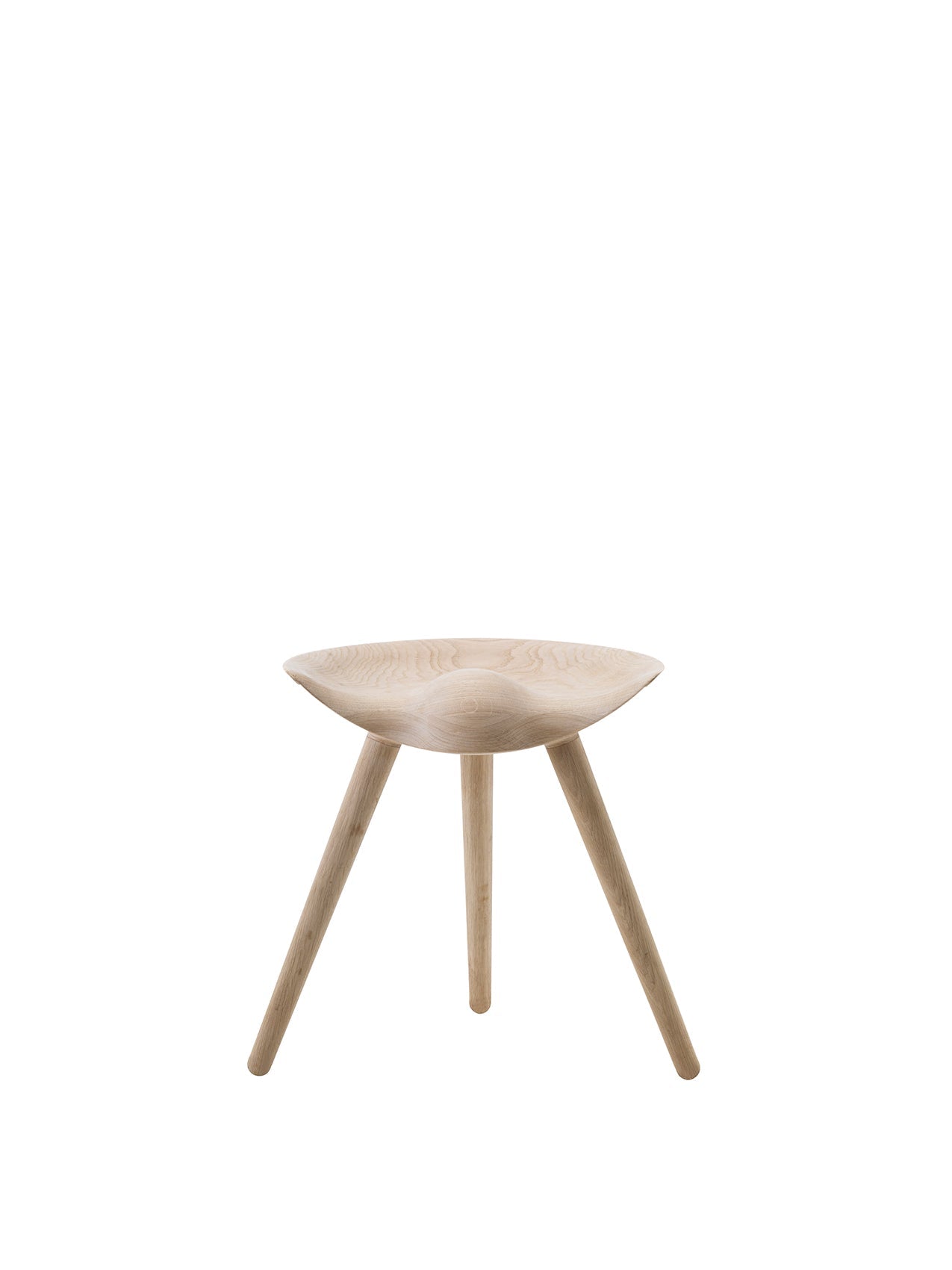 Front view of the ML 42 Stool in Soap Treated Oak. It has three splayed legs and a uniquely sculpted, contoured seat.