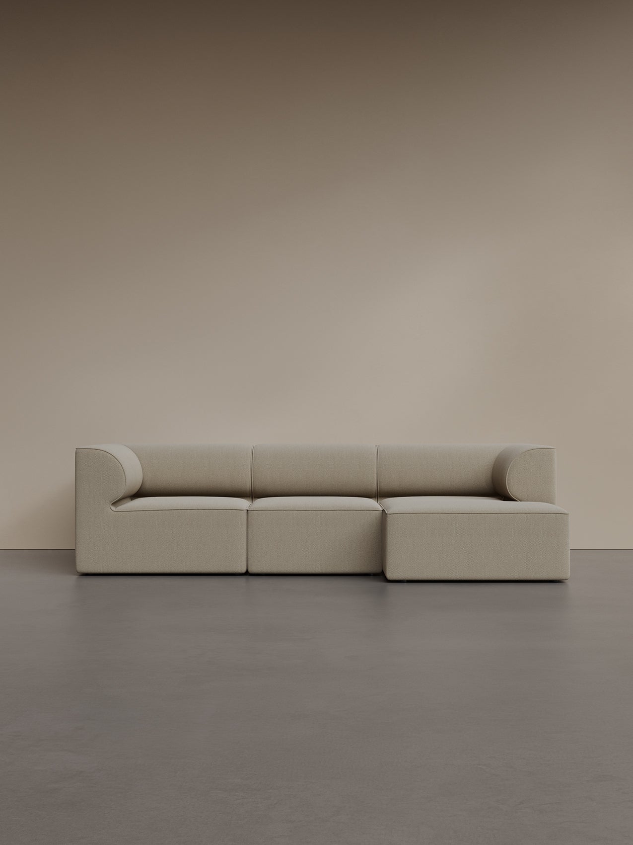 The Eave Modular Sofa, 96, 3-seater, with a right-hand chaise longue in light beige bouclé fabric, seen from the front.