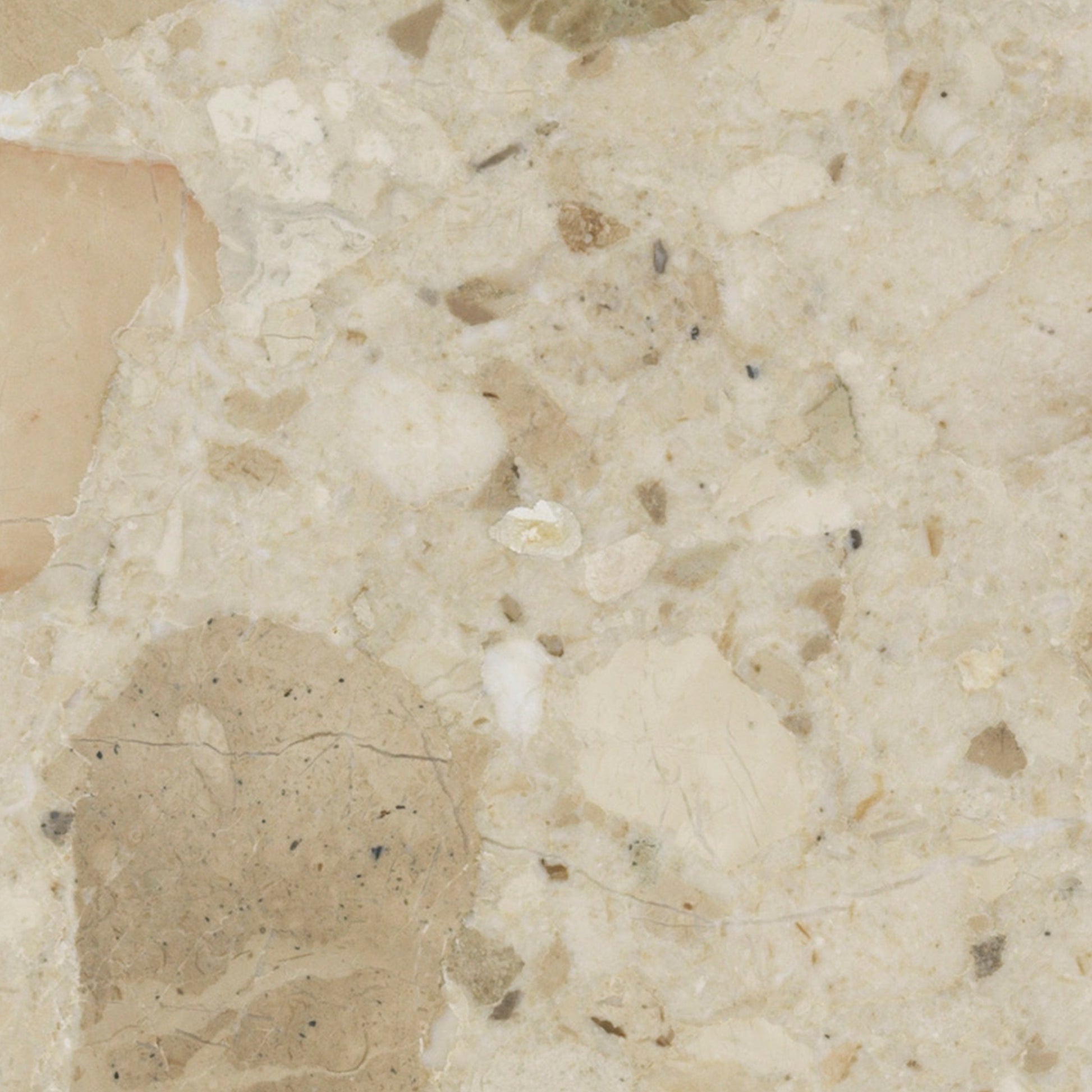 Close-up swatch of Kunis Breccia stone. The polished surface is a composite of beige, tan, and cream-coloured fragments.