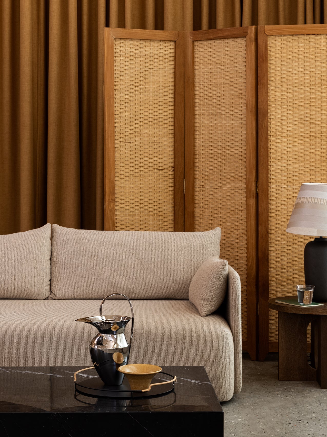 A beige Offset Sofa styled with a Plinth coffee table, Etruscan Pitcher, Androgyne Side Table, and a Torso Table Lamp.