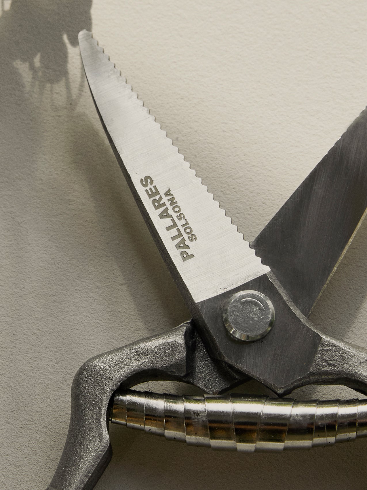 A close-up of the Pallares Plant Pruner, detailing the serrated steel blade with 'PALLARES SOLSONA' engraved on it.
