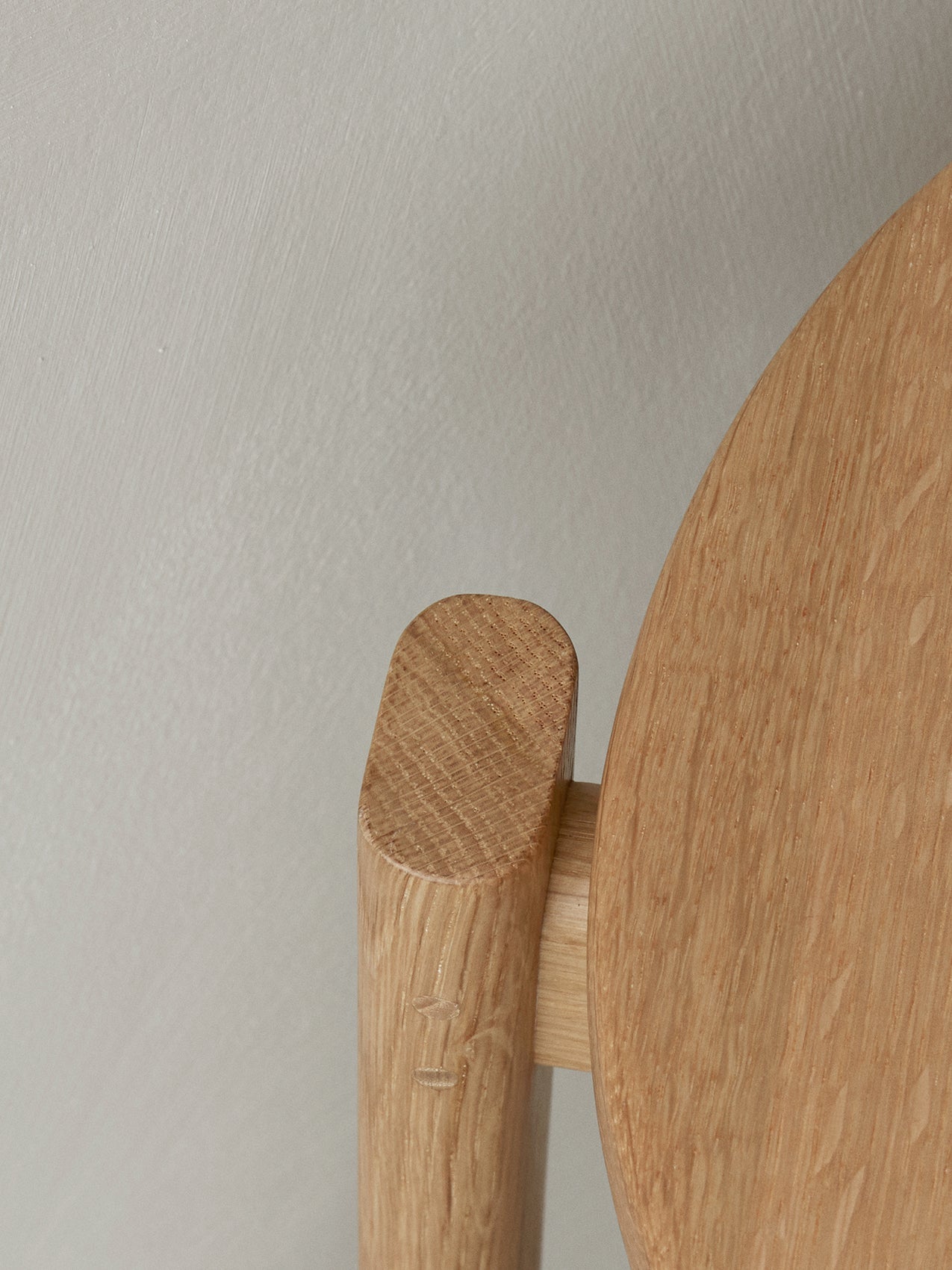 A detailed close-up of the Passage Stool in natural oak, showing the fine craftsmanship and wood grain of the joinery.