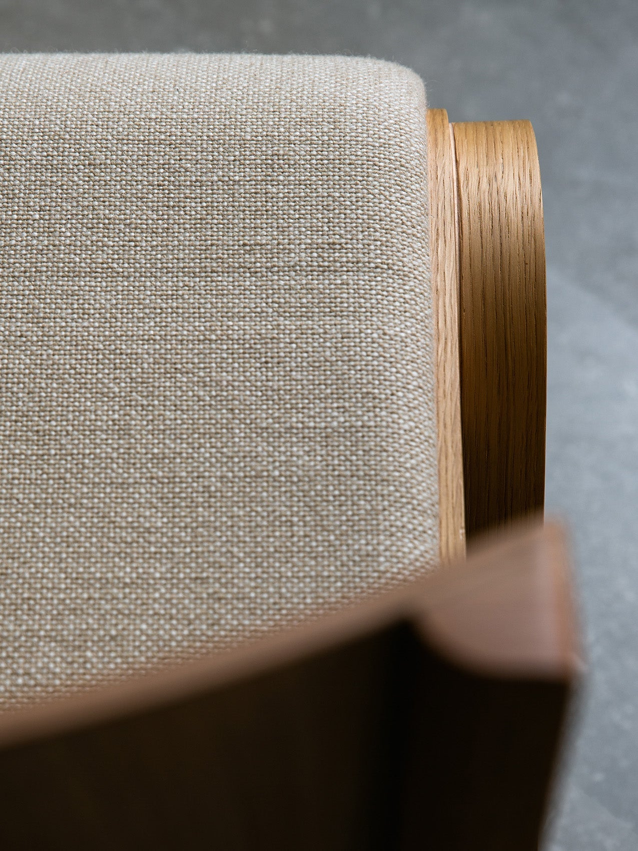 Close-up of the Ready Dining Chair with upholstered seat, showing the texture of the beige fabric and the natural oak frame.