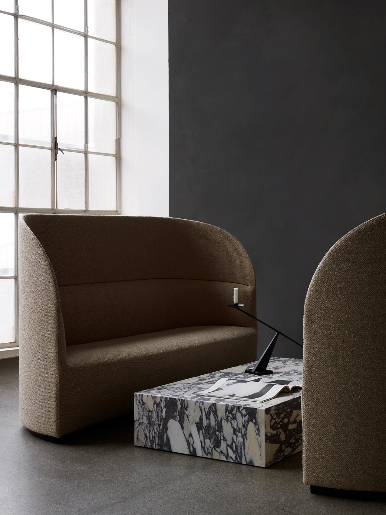 A Tearoom Sofa High Back and Lounge Chair in a minimalist room with a marble Plinth Grand and Interconnect Candle Holder.