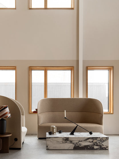 A beige Tearoom Sofa and Lounge Chair with a Plinth marble table, Interconnect Candle Holder and Torso lamp.