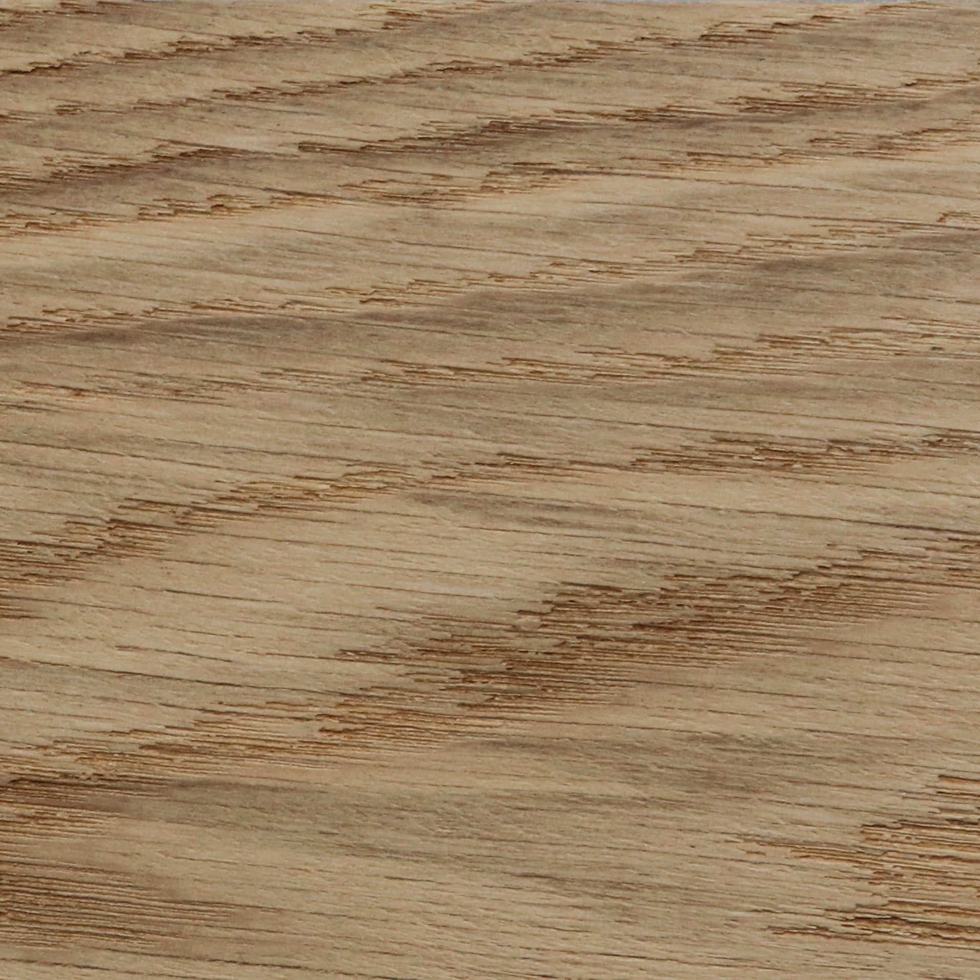 A close-up, detailed shot of a light brown oak wood surface, showing the natural grain and texture running horizontally.