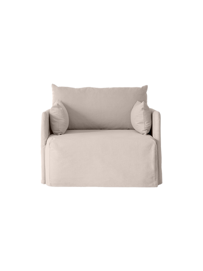 Front view of the Offset Sofa with Loose Cover, a 1-seater armchair in a light grey fabric, isolated on a black background.