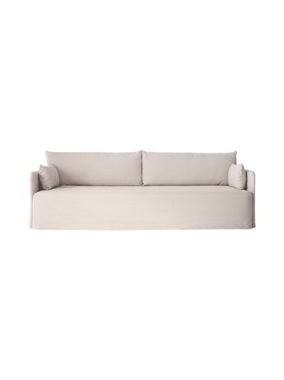 Front view of the Offset Sofa w. Loose Cover, a 3-seater with light grey fabric, two back cushions and two side cushions.