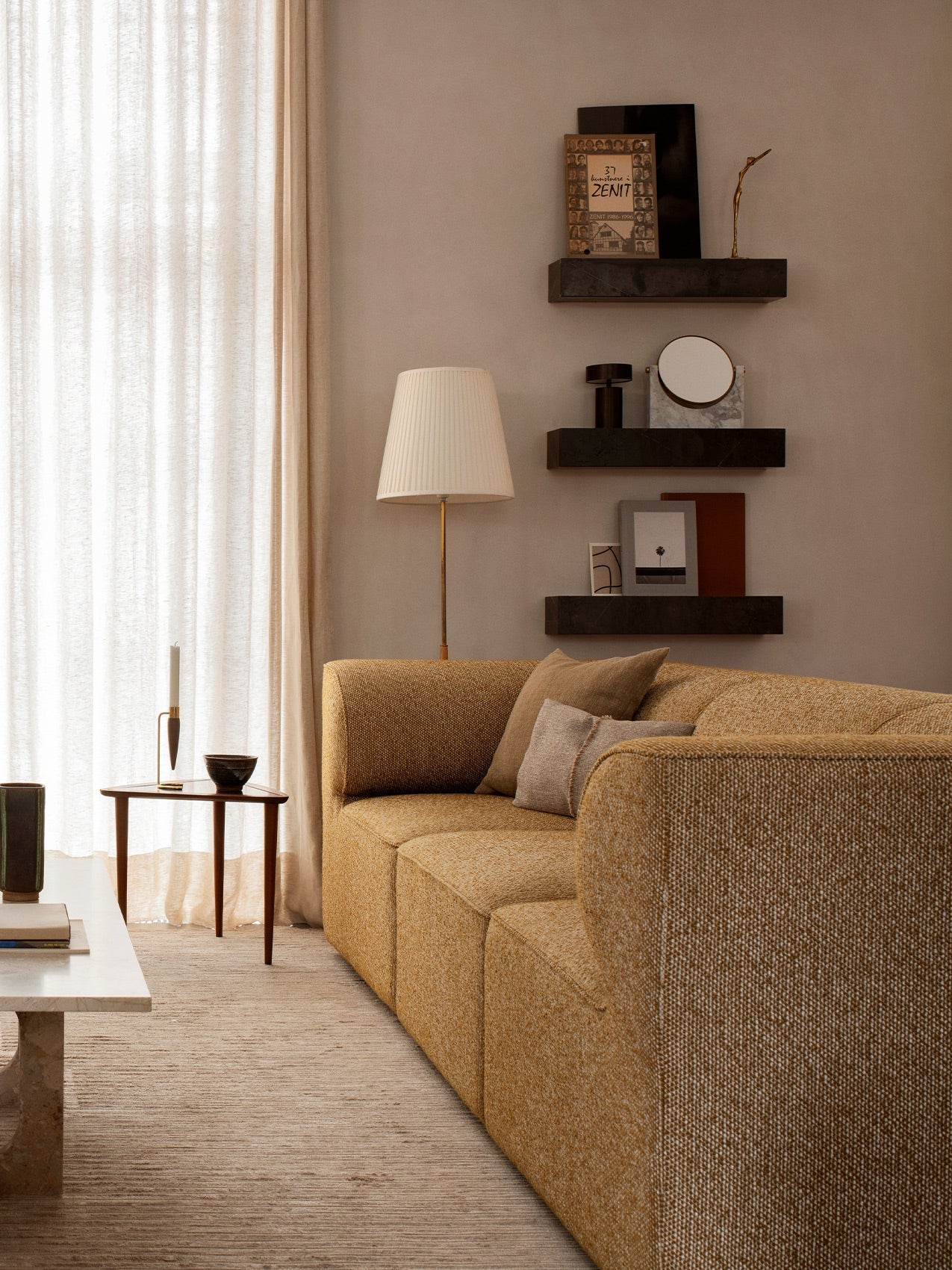Eave Modular Sofa in a yellow textured fabric, styled in a modern living room with decorative shelves and soft lighting.